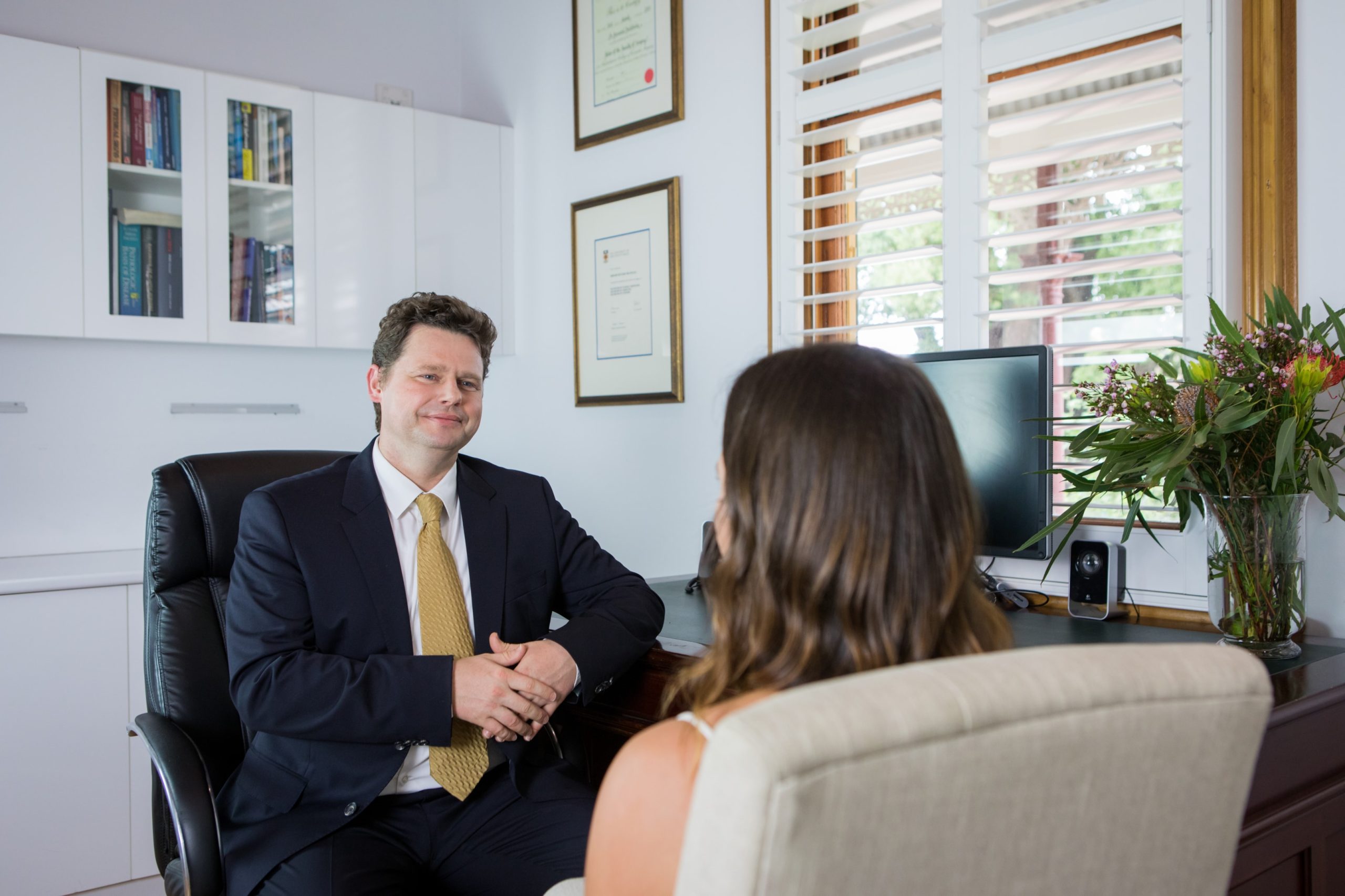 Dr Bernard Beldholm consulting with patient